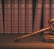 gavel-on-the-background-of-vintage-lawyer-books-co-PLM3A57.jpg